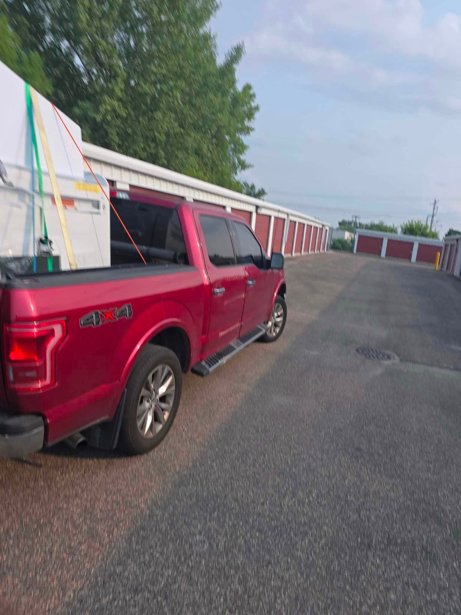 Large white appliance secured upright in the bed of the Royal Family pickup.